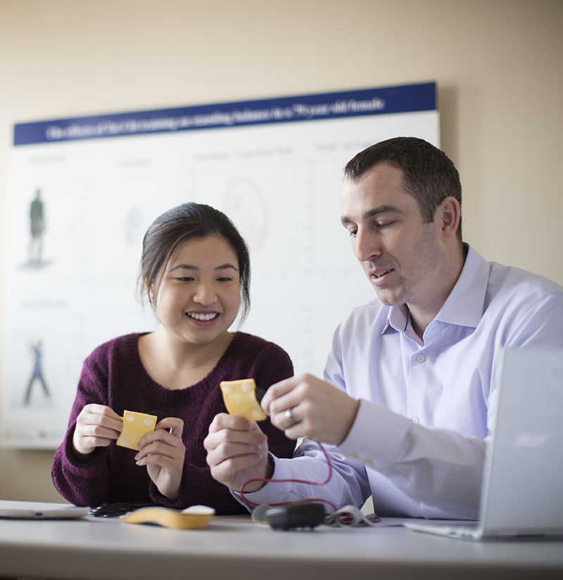 800x825 - Checkerboard - Home - What We Do - 2 Two researchers at the Marcus Institute for Aging Research in Boston, MA examine insoles that can track a person's gait.