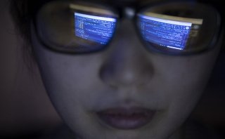 A string of computer code is reflected in the glasses of a researcher at the Marcus Institute for Aging in Boston, MA.
